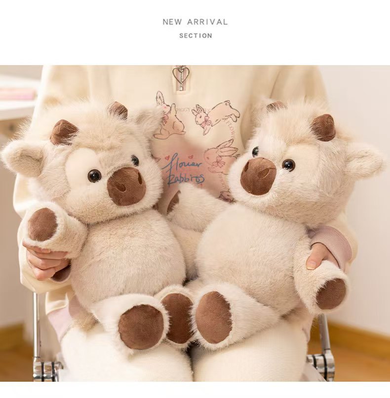 Two CreamCuddle cream Highland cow plush toys shown together; each order includes one plush