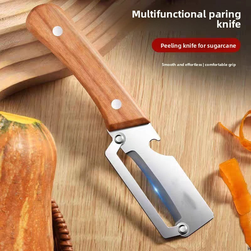 PrepSwift wood-handle peeler beside peeled pumpkin on a wooden surface