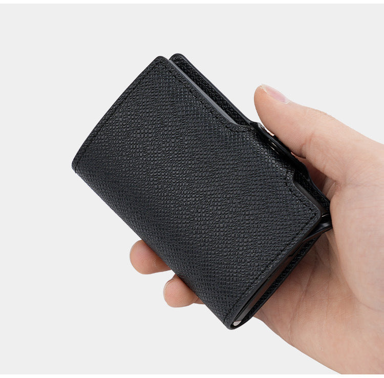 CardGlide black textured pop-up card holder shown closed in one hand