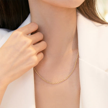 AuriTwist Signature Gold — Fine rope chain styled with a white blazer