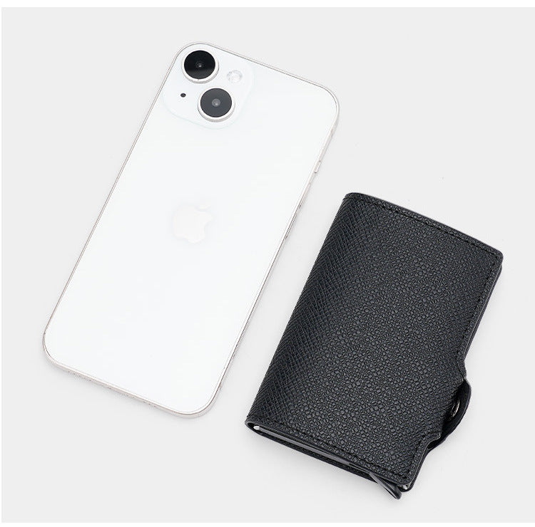 CardGlide black card holder beside a smartphone for a visual size reference