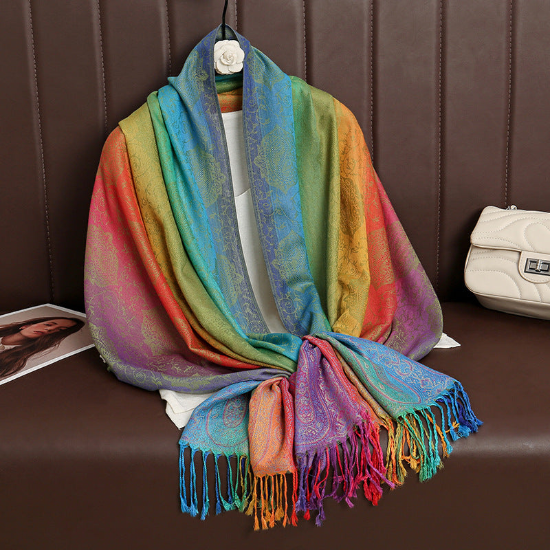 HueWrap rainbow paisley scarf in green, yellow and blue draped to show its tasseled edges