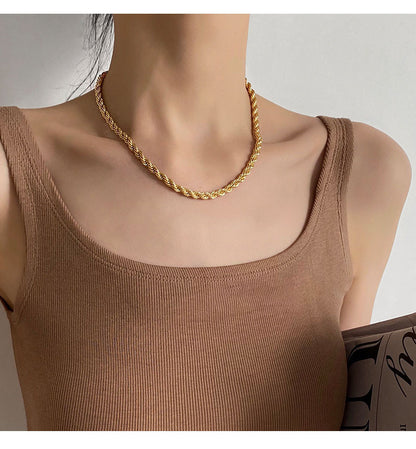 AuriTwist gold-tone rope chain necklace styled with a tan ribbed top